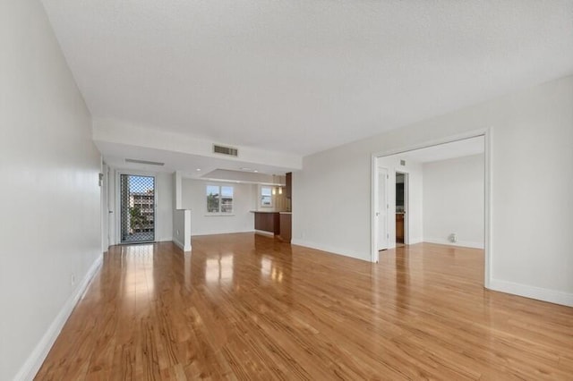 unfurnished living room with light hardwood / wood-style flooring