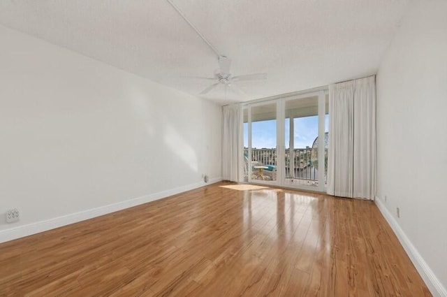 empty room with light hardwood / wood-style flooring and ceiling fan