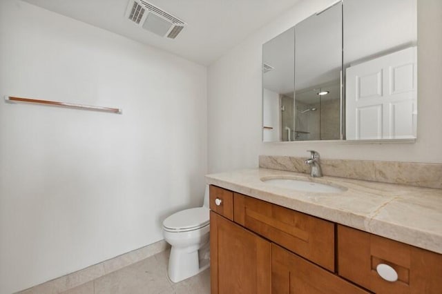 bathroom featuring vanity, walk in shower, toilet, and tile patterned floors