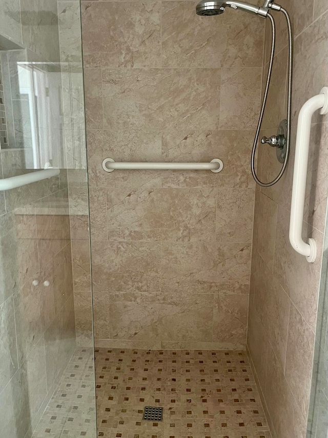 bathroom with a shower with door