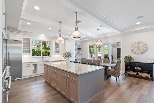 kitchen featuring white cabinetry, a healthy amount of sunlight, a center island, and dark hardwood / wood-style floors