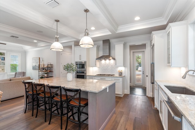 kitchen with wall chimney range hood and white cabinetry