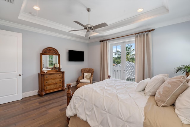 bedroom with a tray ceiling, dark hardwood / wood-style flooring, access to exterior, ceiling fan, and crown molding