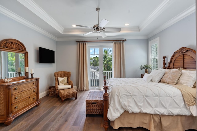 bedroom with ceiling fan, access to exterior, wood-type flooring, a tray ceiling, and ornamental molding