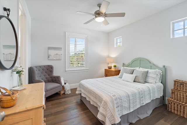 bedroom featuring multiple windows, dark wood-type flooring, and ceiling fan