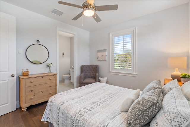 bedroom featuring ceiling fan, ensuite bathroom, and dark hardwood / wood-style floors