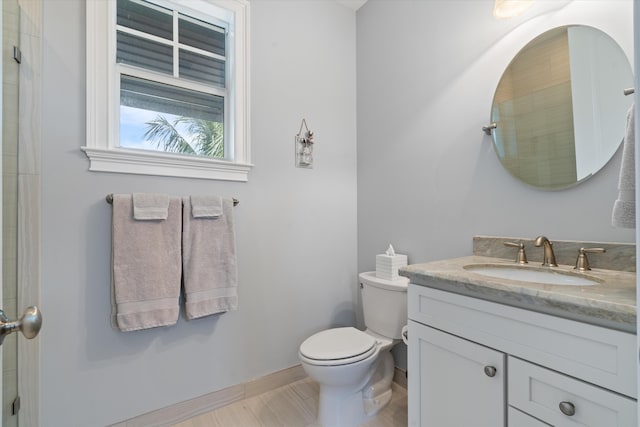 bathroom featuring toilet and vanity