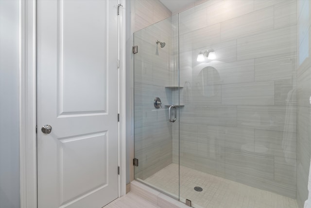 bathroom featuring a shower with door