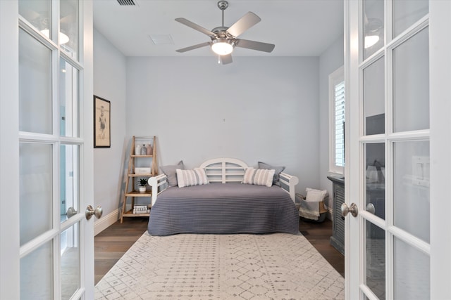 bedroom featuring dark hardwood / wood-style flooring, french doors, and ceiling fan