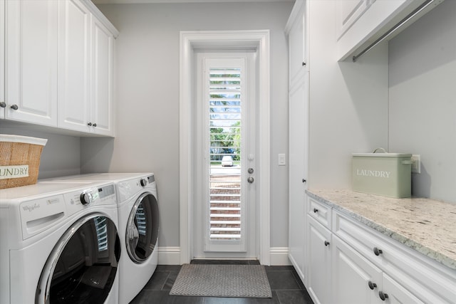 laundry room with cabinets, independent washer and dryer, and dark tile patterned floors