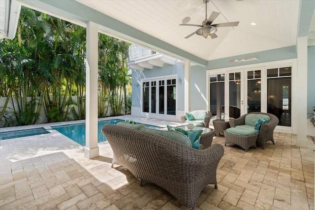 view of patio with outdoor lounge area, french doors, a fenced in pool, and ceiling fan