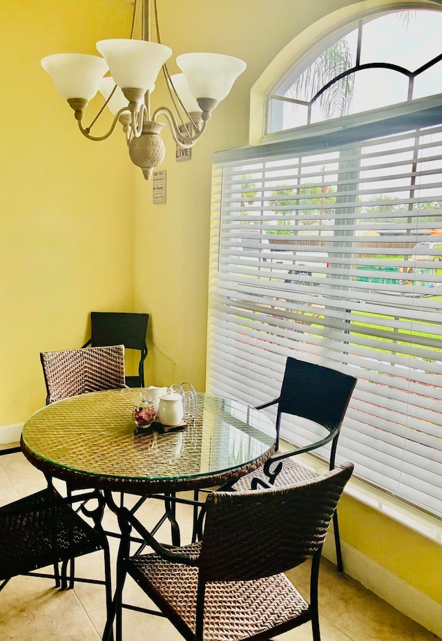 tiled dining space featuring a notable chandelier