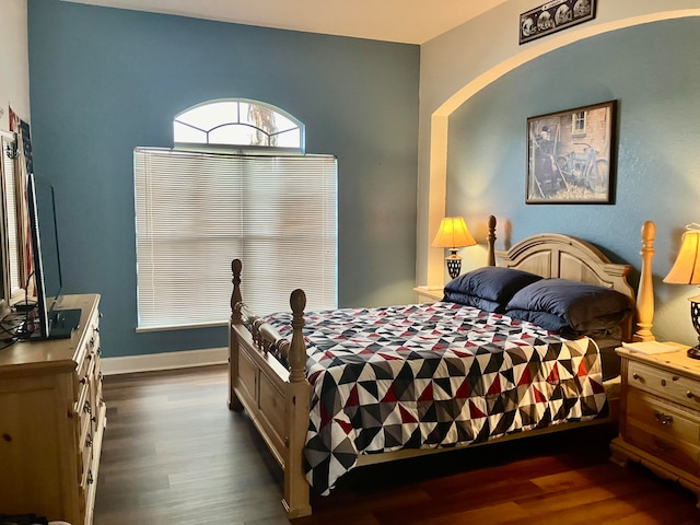 bedroom with dark hardwood / wood-style floors