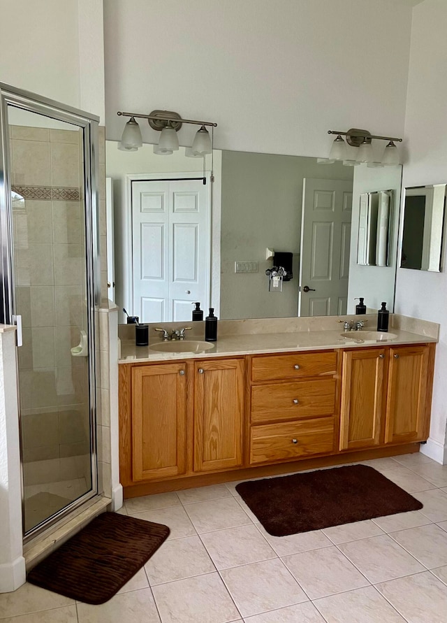 bathroom featuring a shower with door, tile patterned floors, and vanity