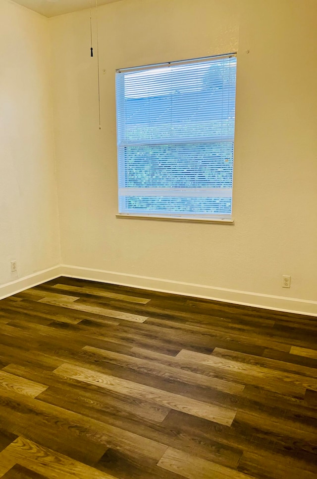 unfurnished room with dark hardwood / wood-style floors