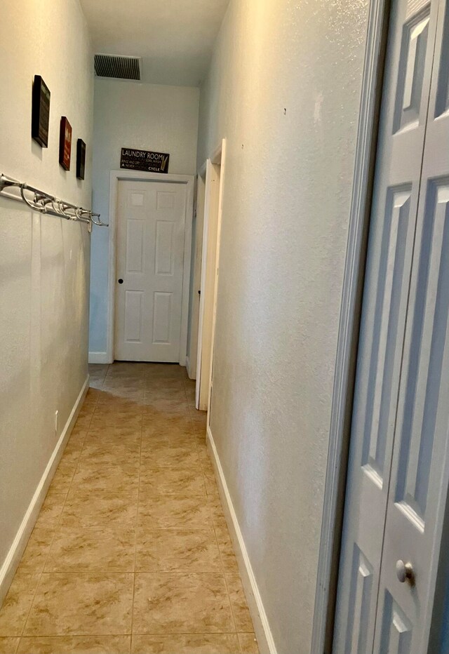 hallway featuring light tile patterned flooring