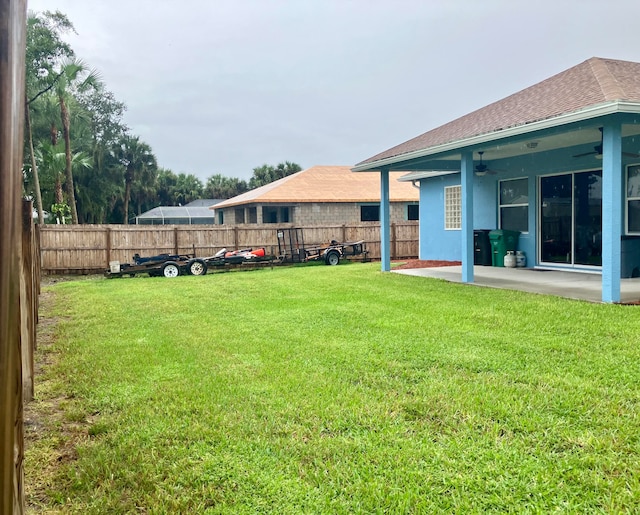 view of yard featuring a patio area and ceiling fan