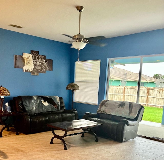 tiled living room with ceiling fan