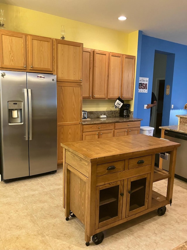 kitchen with appliances with stainless steel finishes and light tile patterned floors