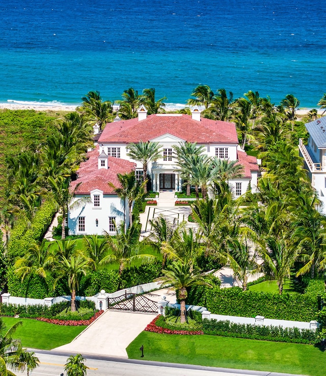 birds eye view of property featuring a water view and a beach view