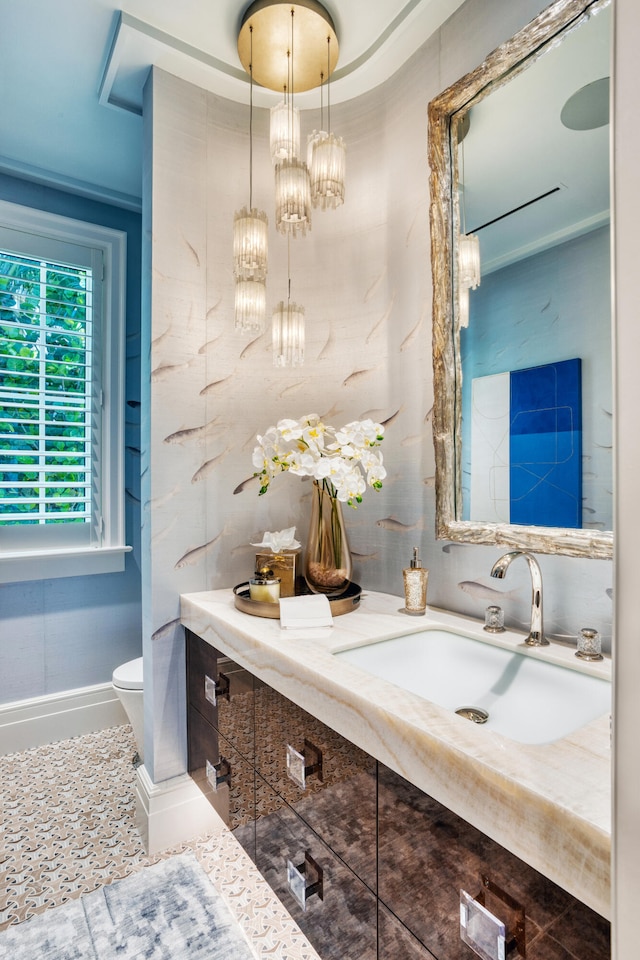 bathroom featuring vanity, toilet, and a tray ceiling