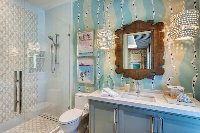 bathroom with vanity, tile patterned flooring, toilet, and walk in shower