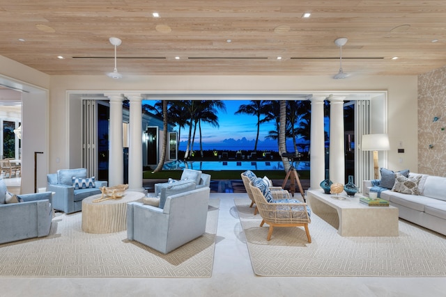 living room featuring decorative columns and wooden ceiling