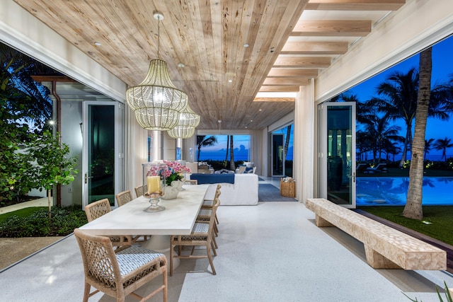 dining space featuring a chandelier and wooden ceiling