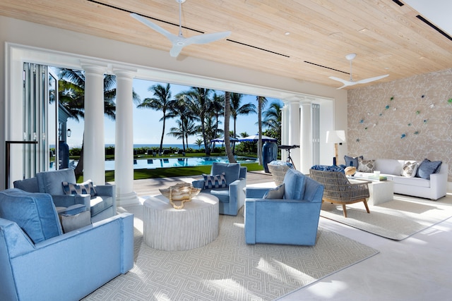 living room with wood ceiling, a healthy amount of sunlight, a water view, and ceiling fan