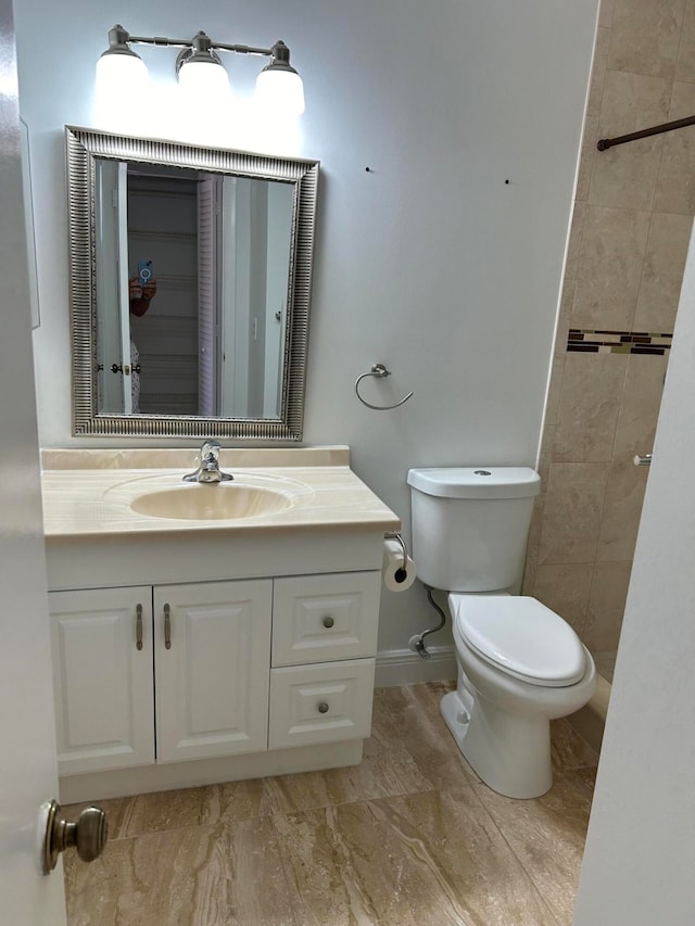 bathroom with toilet and vanity