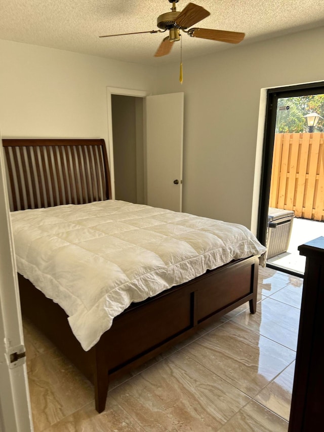 bedroom featuring a textured ceiling and ceiling fan