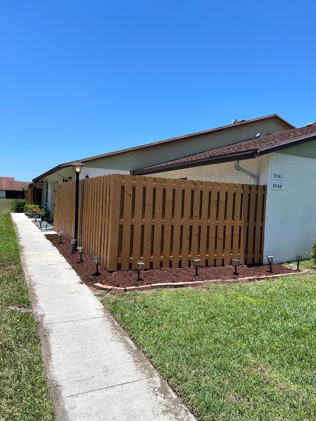 view of side of home with a lawn