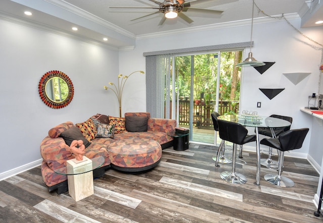 living room with hardwood / wood-style flooring, ceiling fan, and crown molding