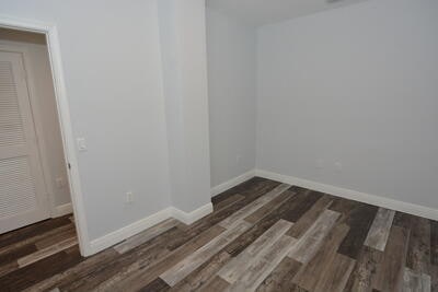 empty room with dark hardwood / wood-style floors