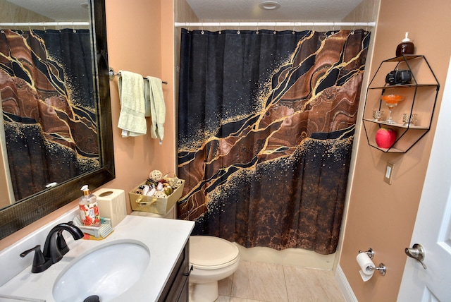 bathroom with tile patterned floors, vanity, a textured ceiling, and toilet