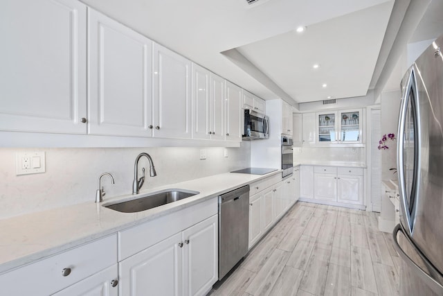 kitchen featuring white cabinets, light stone countertops, sink, and stainless steel appliances