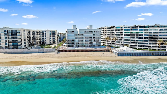 view of swimming pool featuring a beach view and a water view