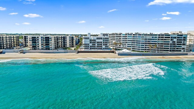 view of pool with a water view and a view of the beach