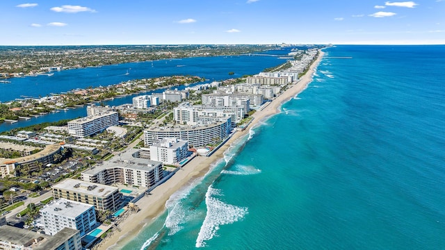 birds eye view of property with a water view and a beach view