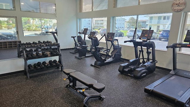 gym with baseboards and a wealth of natural light