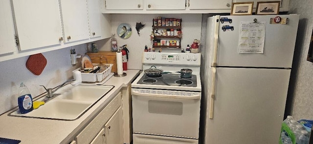 kitchen with white cabinets, white appliances, and sink