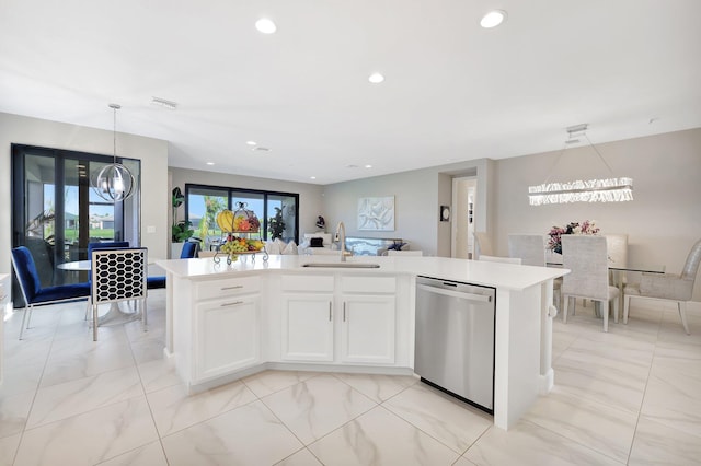 kitchen featuring sink, dishwasher, an island with sink, decorative light fixtures, and white cabinets