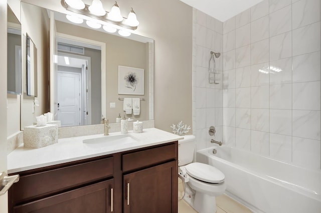 full bathroom featuring vanity, tiled shower / bath combo, toilet, and tile patterned floors