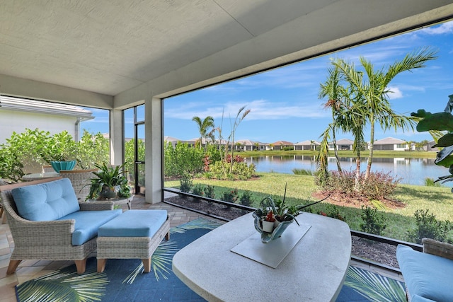 sunroom / solarium featuring a water view