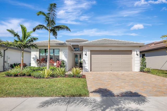 view of front of home with a front lawn and a garage