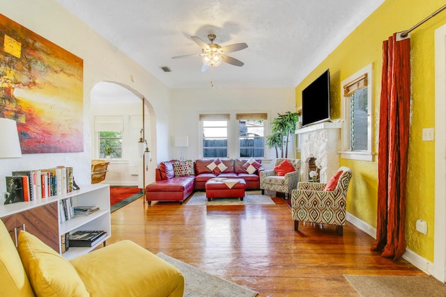 living room with hardwood / wood-style floors and ceiling fan