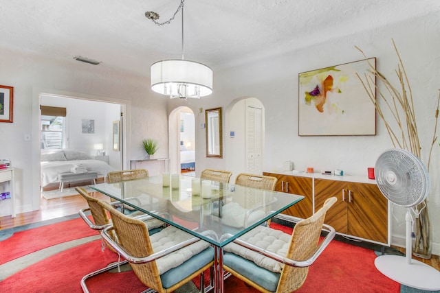 dining space with a textured ceiling and carpet