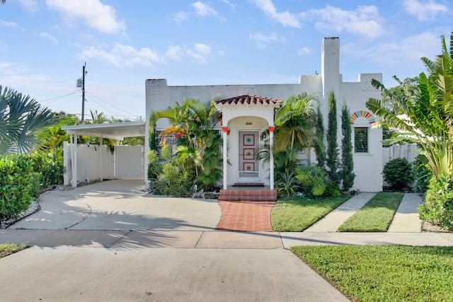 mediterranean / spanish home featuring a carport