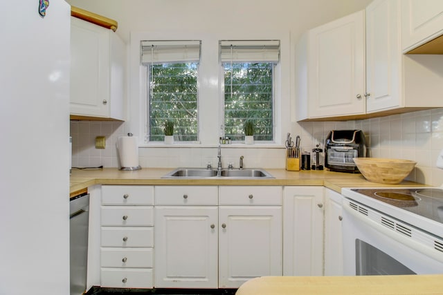 kitchen featuring white electric range, sink, white cabinets, and decorative backsplash