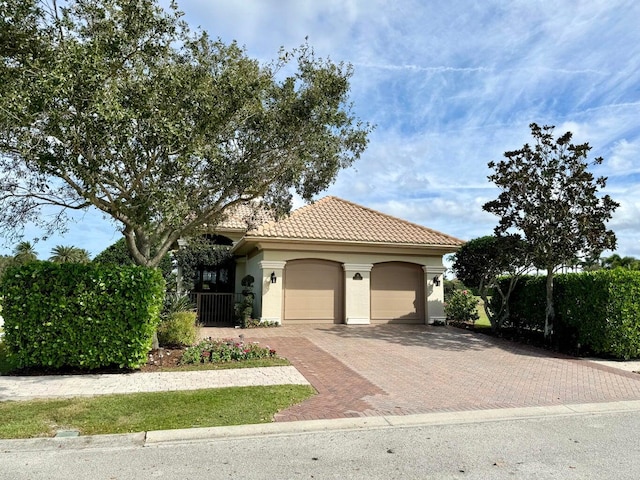 mediterranean / spanish home with a garage